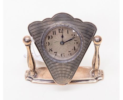 A silver table clock with engine turned detail on face, on swivel stand&nbsp; Birmingham silver 1931 by S Blanckensee &amp; S