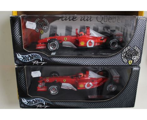 A pair of Hot Wheels models: Ferrari 1:18 scale; F2003-8A Michael Schumacher and Canadian Grand Prix winner 2002. (2)