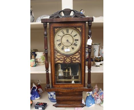 A late 19th Century American style wall clock, scroll and inlay design, retailed in Loughborough