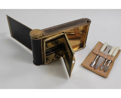 An early 20th Century camera shaped ladies vanity compact with music box, manicure set and mirror