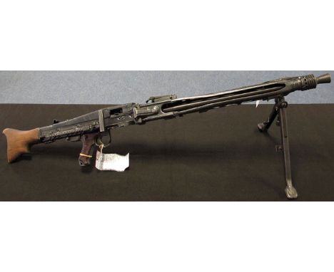 Machine Gun: A NAZI MG42 light machine gun with functioning action. Marked 'cof' with Waffenampt marks. In good condition and