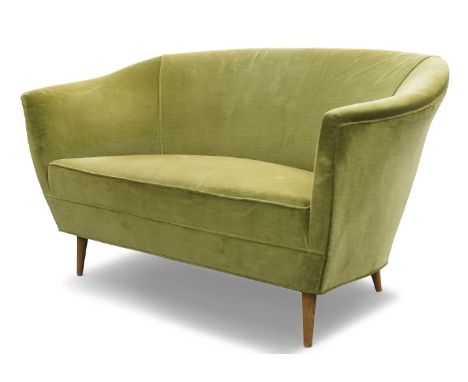 An Italian two seat sofa, c.1950,With curved back to down swept arms, upholstered in green velvet fabric, on tapered beech fe