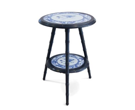An Aesthetic Movement ebonised two tier occasional table,c.1870,With two graduated circular tiers, each inset with blue and w