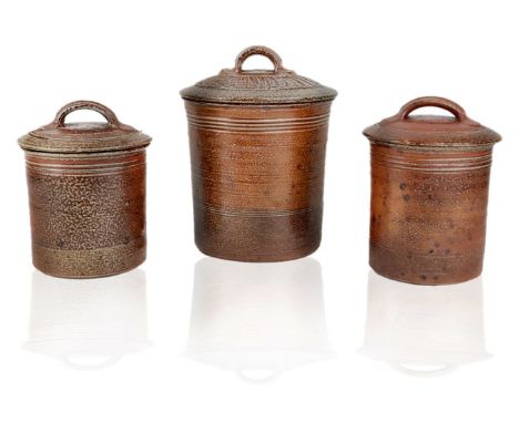 Peter Starkey (British b.1945), three stoneware lidded jars,c.1980, each impressed with potter's seal,Each of tapered cylindr