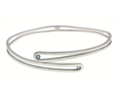 A slave bangle stamped 925, with 2 small blue stones approx 7cm dia gross weight 15.1gApprox 1 pieces