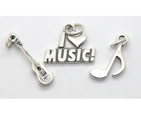 Three silver music charms. P&amp;P Group 1 (£14+VAT for the first lot and £1+VAT for subsequent lots) 