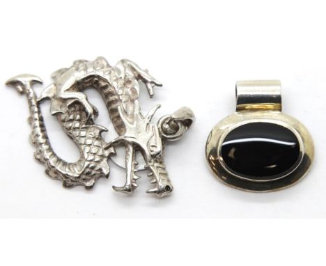 Silver and onyx oval pendant and a presumed silver dragon pendant. P&amp;P Group 1 (£14+VAT for the first lot and £1+VAT for 