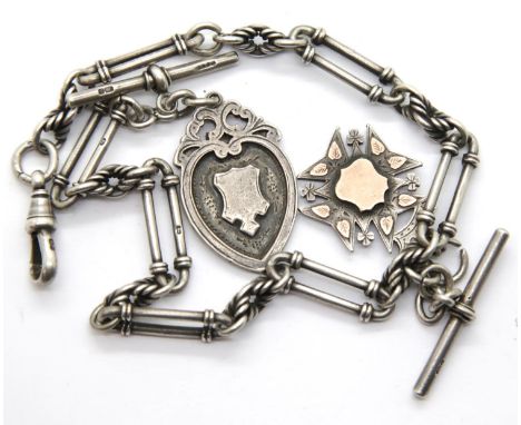 Victorian hallmarked silver double Albert watch chain of twisted trombone links, having two silver fobs and T-bars, 66g. P&am