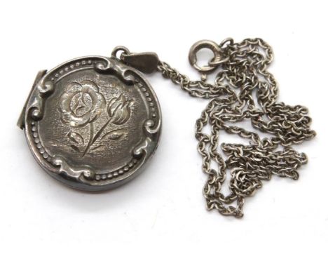 Vintage silver circular locket with relief design on a silver neck chain. P&amp;P Group 1 (£14+VAT for the first lot and £1+V