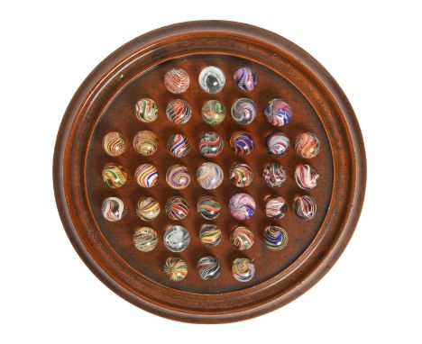 A Victorian turned mahogany solitaire board and thirty-five glass marbles, 26.5cm diam Several marbles chipped