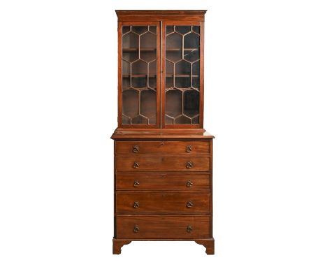 A George III mahogany bookcase, with hexagon pattern glazing bars and adjustable shelves, the lower part with a secretaire ab