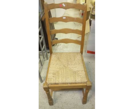 A beech framed ladder back rush seated chair, together with footstool and a Windsor elbow chair 