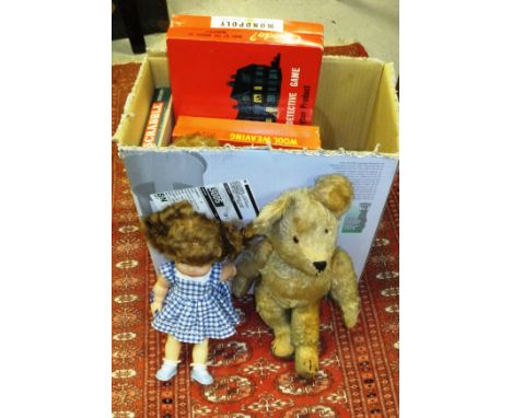 An early to mid 20th Century gold plush woodwool filled bear with growler, two plastic dolls and various games including Scra