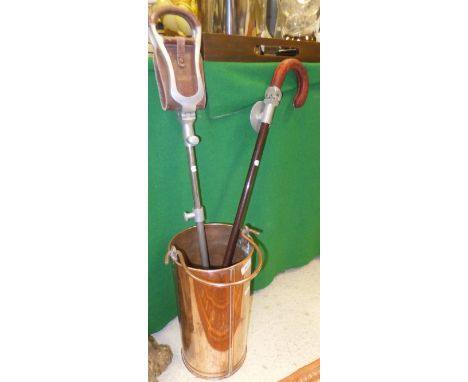 A copper cylindrical bucket with handle, together with a shooting stick and a shooting walking stick