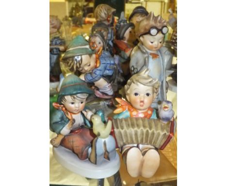 A collection of ten Goebel Hummel figures to include "Let's sing", "Boy with bird upon his feet", "Singing ....", "Retreat to