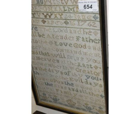 A needlework sampler by Jane Couper, aged 16, dated 1762, featuring the alphabet and a verse from the Bible, with crown benea