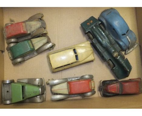 A collection of eight early 20th Century tin plate toy cars including a Schuco saloon car, German clockwork car bearing inscr