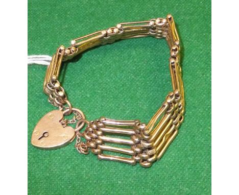 A 9 carat gold gate link bracelet with heart shaped lock, and a 22 carat gold wedding band CONDITION REPORTS Wear and scuffs.
