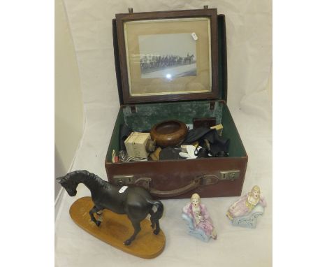 A small vintage suitcase containing a collection of miscellaneous items to include military photographs, beaded bag, vintage 