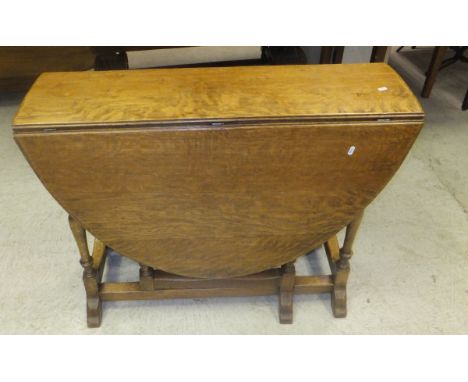 An oak gate-leg dining table and a mahogany sofa coffee table