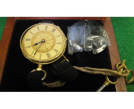 An 18 carat gold and enamel cased pocket watch converted to a wristwatch