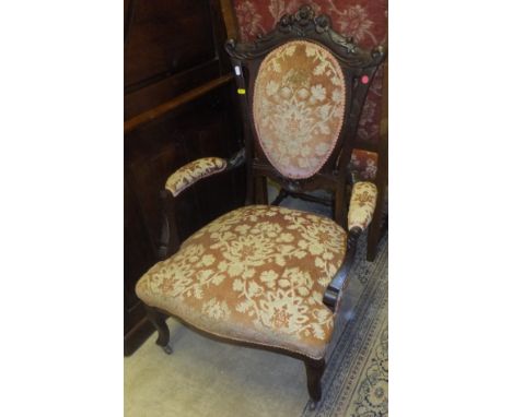 A pair of Victorian mahogany framed salon chairs with serpentine front seat and peach ground upholstery