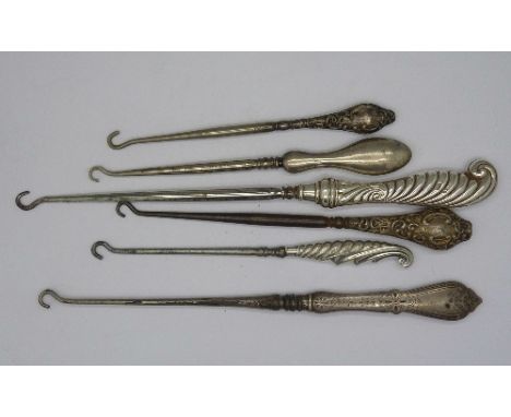 Six silver handled button hooks