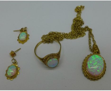 A 9ct gold and synthetic opal jewellery set, comprising a ring, pendant and chain and a pair of earrings, weight 9.8g