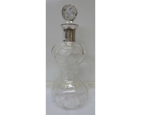 A white metal topped decanter