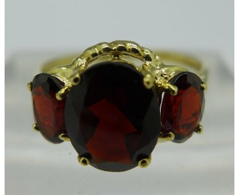 A 9ct gold and three stone garnet ring, weight 1.8g, size O