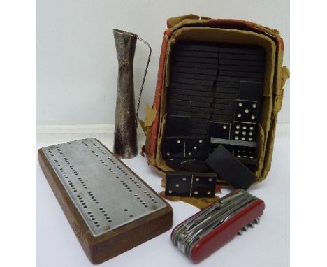 A set of Bakelite dominoes, Swiss Army knife, cribbage board and posy vase