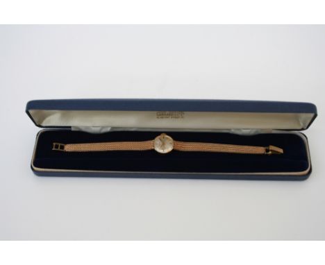 Ladies 9ct gold Garrard wristwatch, the circular silvered dial with baton markers, manual wind swiss movement on 9ct flexible