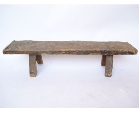 An 18th/19th Century oak pig bench, the single plank top with cleated ends on four splayed legs.
146 x 35 x 33cm. 