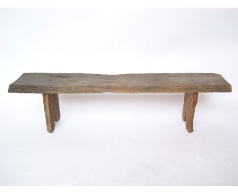A late 19th/early 20th Century French chestnut pig bench, the single plank top on two supports.
143 x 32 x 35cm. 