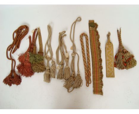 A collection of early 20th Century passementerie tassels, a twisted cord curtain tie back etc. 