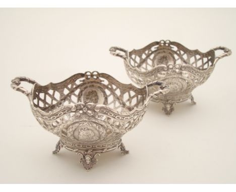 A pair of 18th Century Louis XV style silver twin handled sweetmeat baskets, of oval form, the pierced lattice work body drap