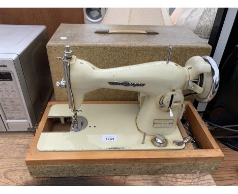 A DELUXE SOVEREIGN VINTAGE BOXED SEWING MACHINE 