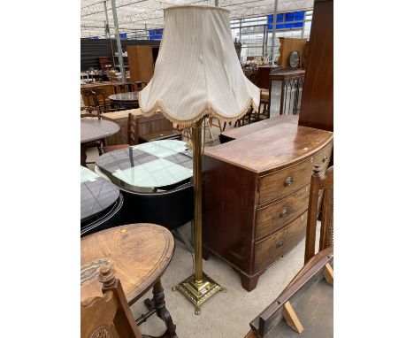 A BRASS CORINTHIAN COLUMN STANDARD LAMP COMPLETE WITH SHADE, ON PAW FEET 