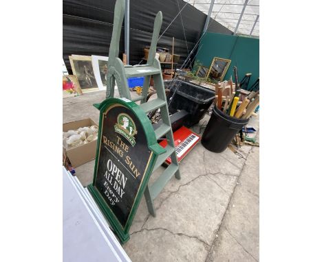 A RISING SUN PUB SIGN AND A SET OF STEP LADDERS 