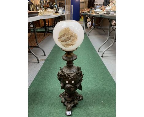 A BRONZE OIL LAMP WITH DECORATIVE DETAIL OF AN EAGLE AND AN ORNATE GLASS SHADE AND FUNNEL 