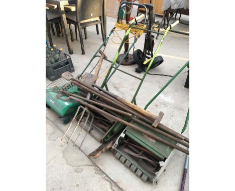 THREE VARIOUS LAWN MOWERS ALONG WITH A COLLECTION OF GARDEN TOOLS INCLUDING FORKS, SPADES ETC. 