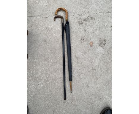 A WALKING STICK AND UMBRELLA 