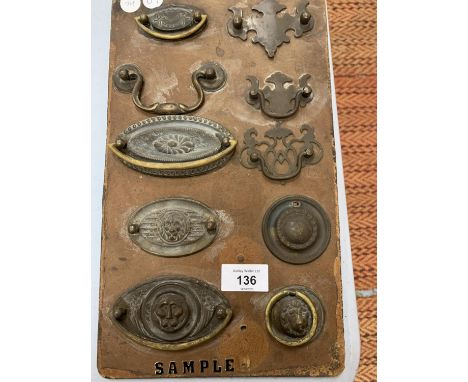 A VINTAGE IRONMONGERY DISPLAY BOARD FOR BRASS SAMPLES 