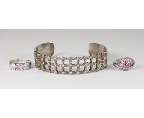 A silver bangle and two silver rings set with rose quartz and other stones