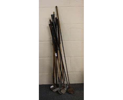 A quantity of vintage golf clubs