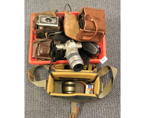 A Pentax SLR camera and other cameras