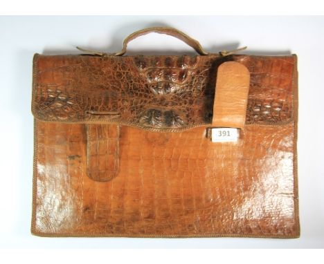 A vintage crocodile skin attaché case