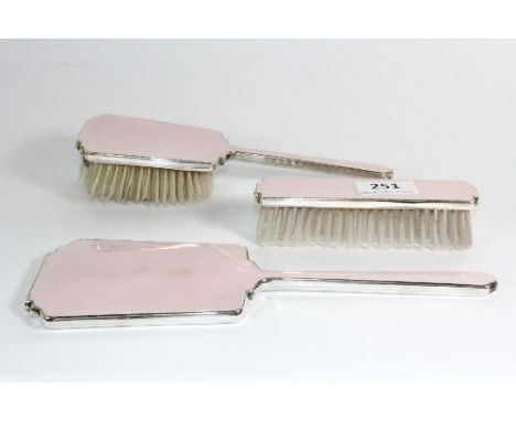 A three piece silver and enamel dressing set