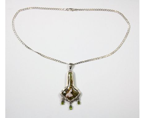 A .925 silver mounted Art Nouveau style enamel pendant decorated with three suspended peridot on a .925 silver chain.