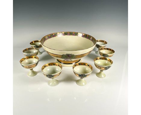 A footed punchbowl with 8 matching stemmed cups in an art nouveau style with a grape vine motif. The bowl 5.25"H x 12"dia is 